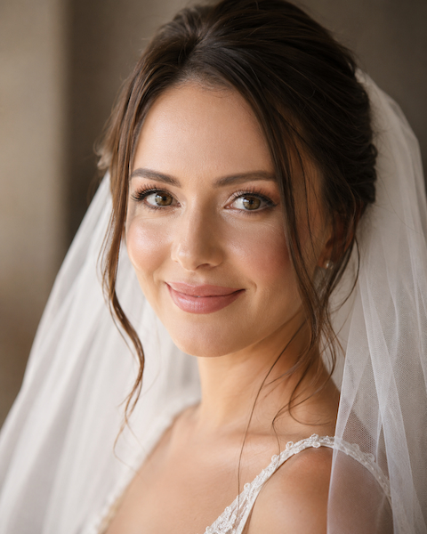 Sarah M., bride laughing on wedding day with glowing skin
